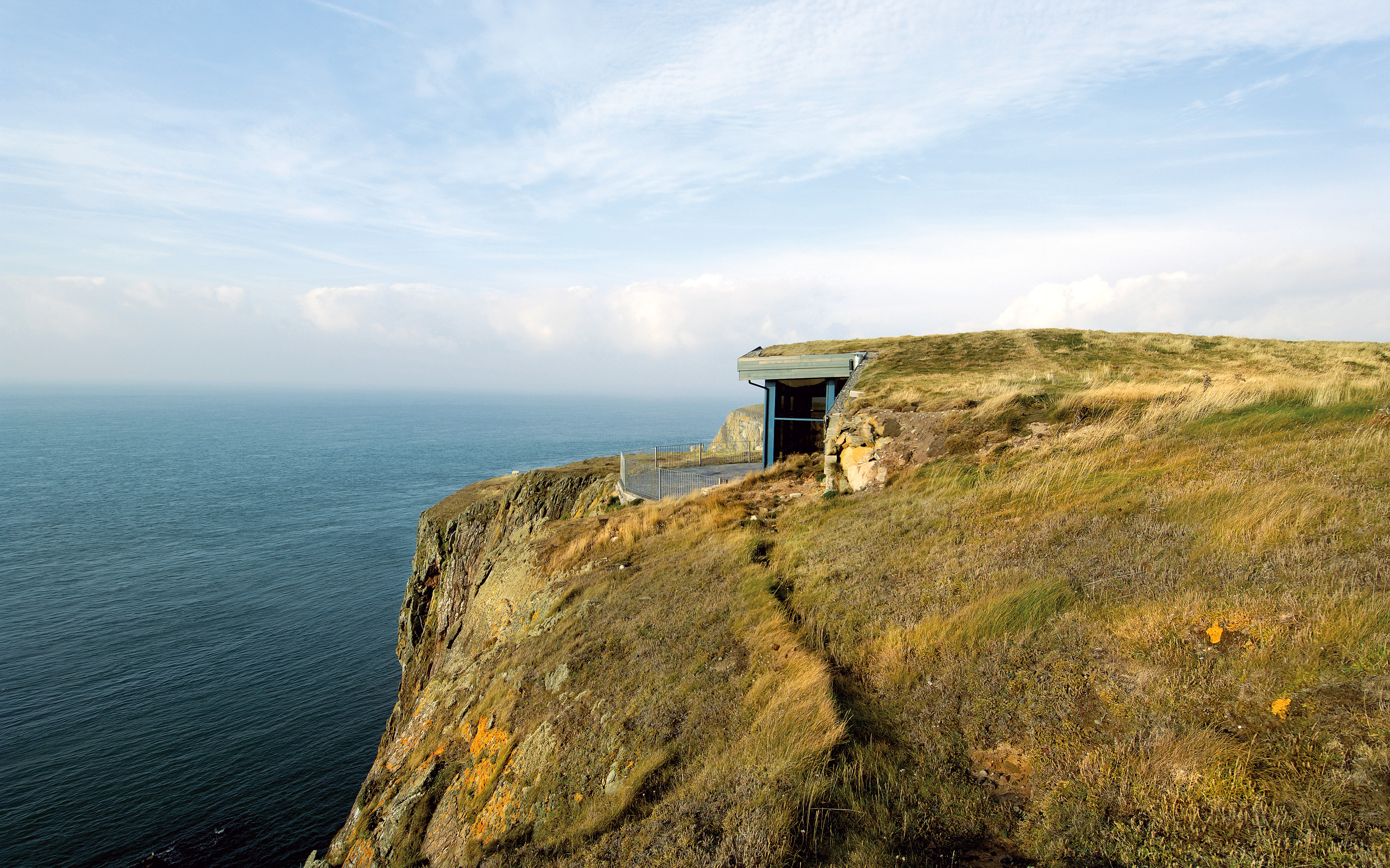 Building with green roof on cliff