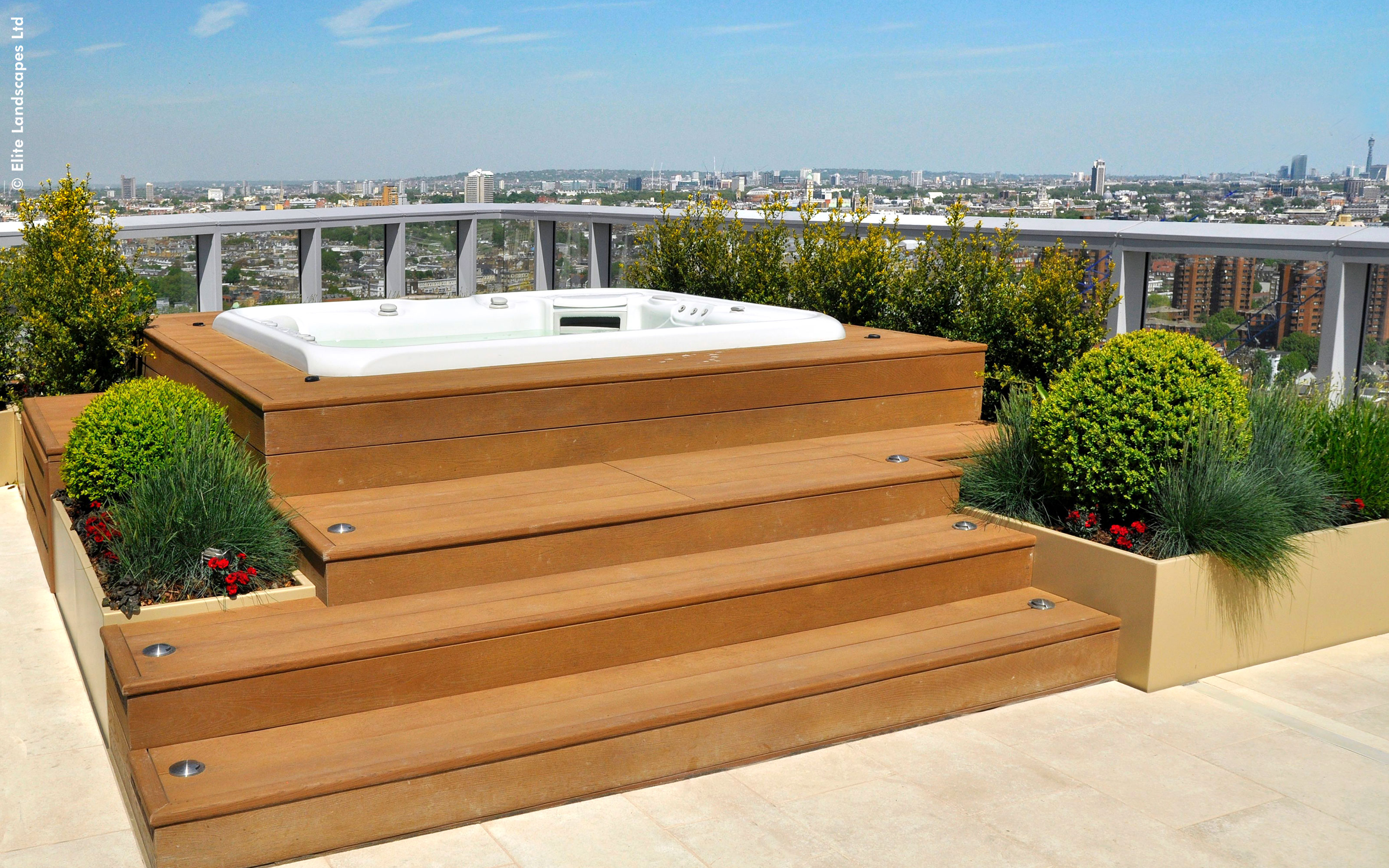 Roof terrace with wooden decking and a hot tub