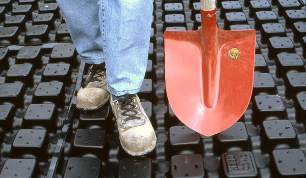 Green roof contractor standing on drainage elements