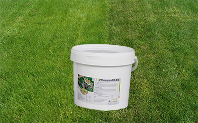Bucket with fertilizer on the lawn