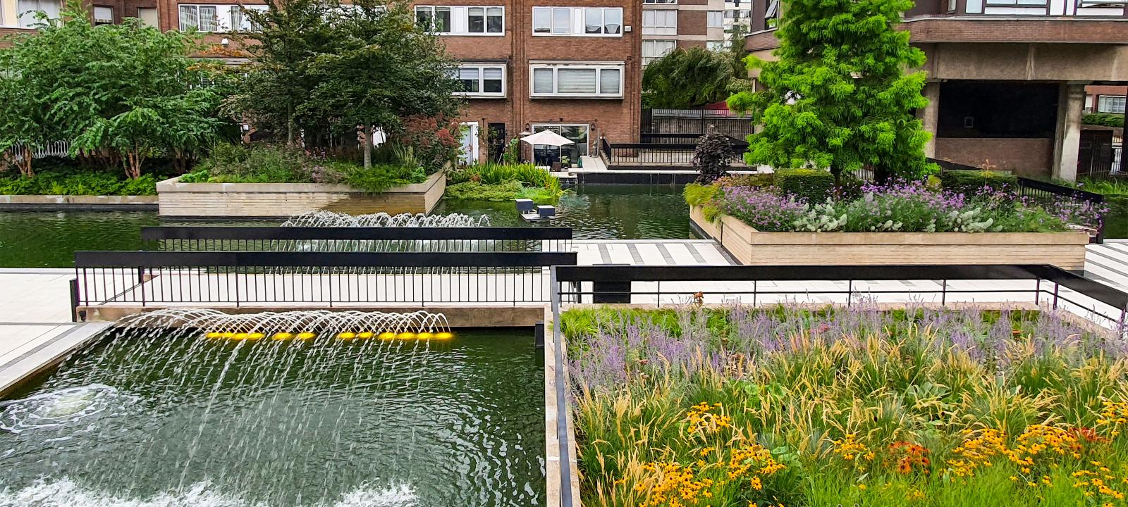 Plant beds, water jets and fountains in front of residential buildings