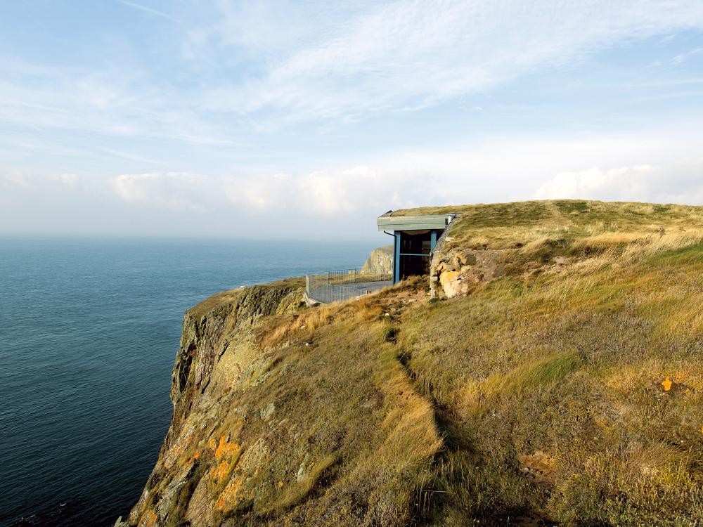 Building with green roof on a cliff