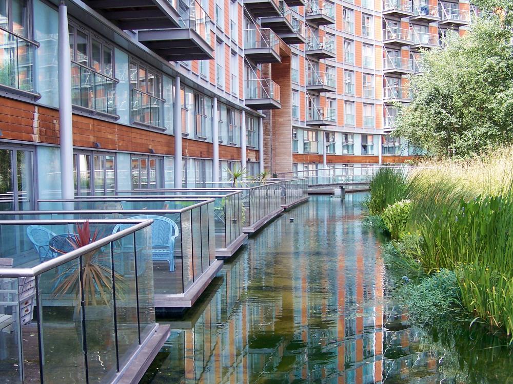 Water channel adjoining balconies of a residential building