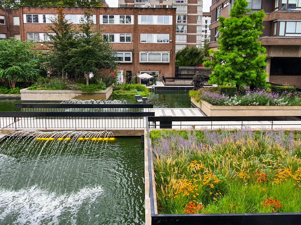 Plant beds, water jets and fountains in front of residential buildings