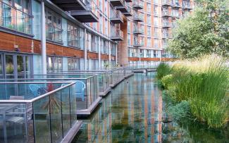 Water channel adjoining balconies of a residential building