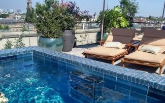 Swimming pool and deck chairs on a roof terrace