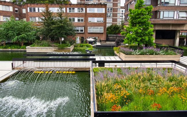 Plant beds, water jets and fountains in front of residential buildings